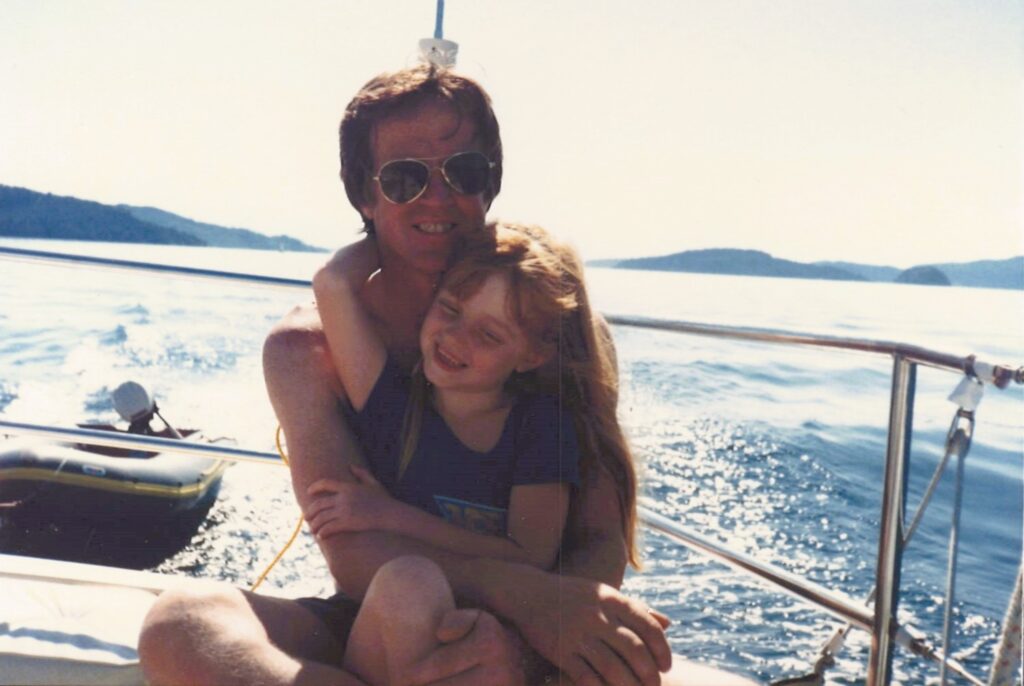 dad and daughter on a sailboat